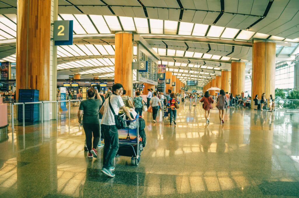 traveling through an airport happily with baggage